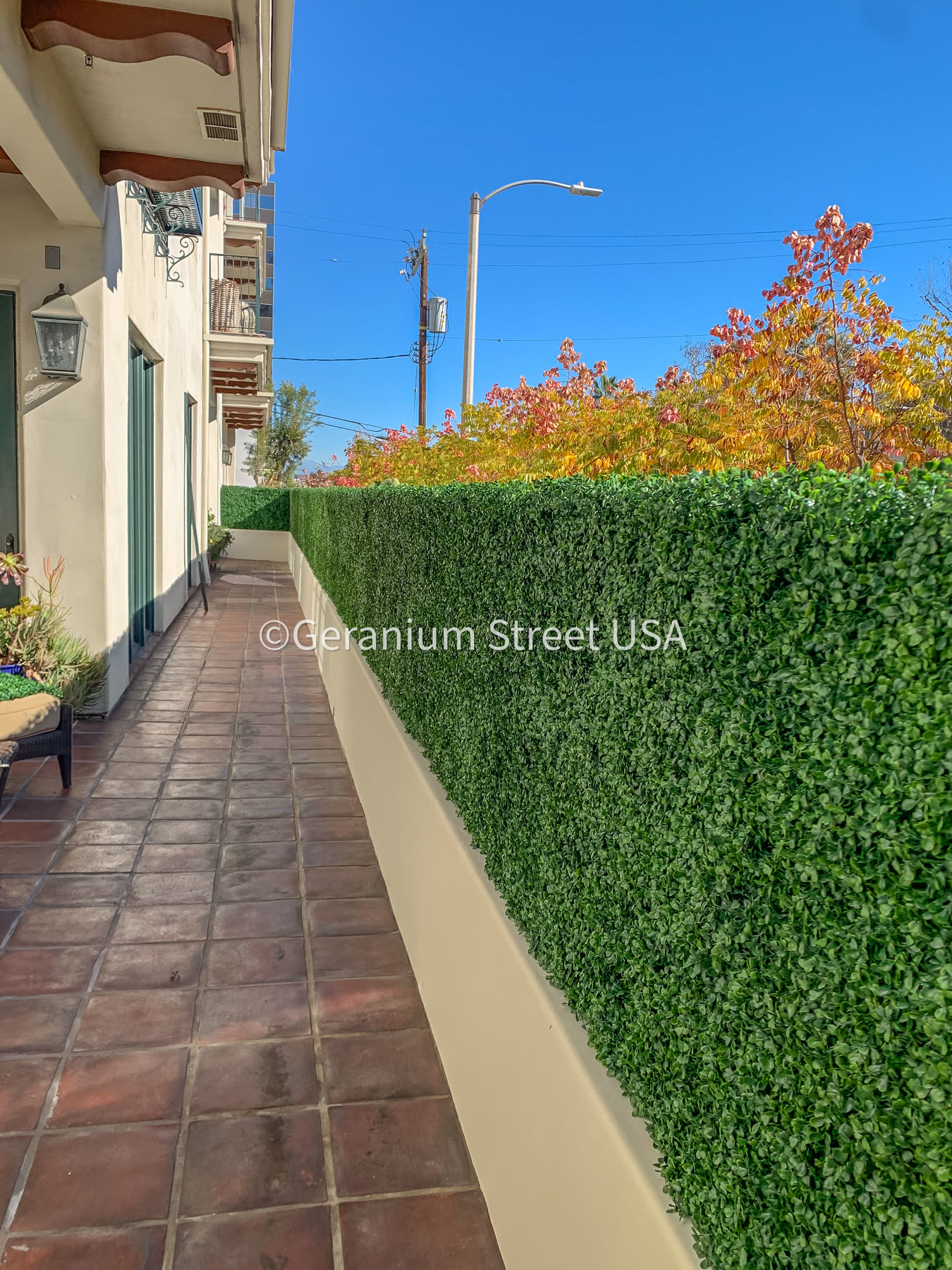 Backyard after artificial hedge fence extension with added height